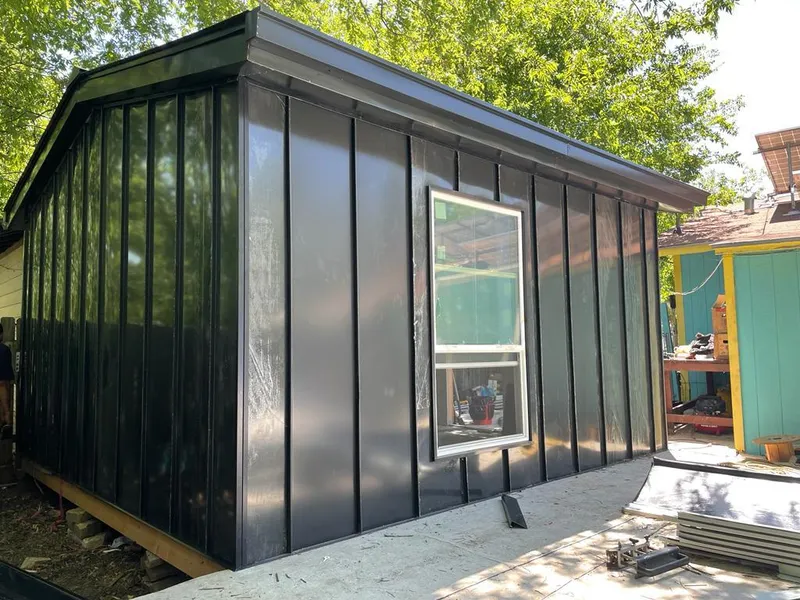 Black standing seam metal wall panels for Roof Inspection in Pensacola Station