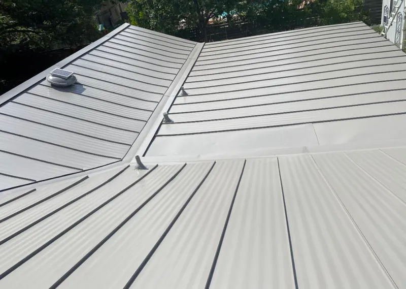 Solar attic fan installed on a metal roof for Roof Ventilation in Pensacola Station